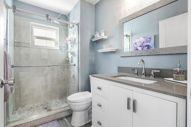 bathroom featuring vanity, wood-type flooring, an enclosed shower, and toilet