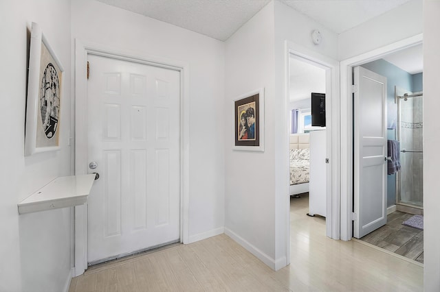 foyer featuring light hardwood / wood-style floors and a textured ceiling