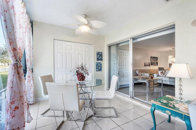 dining space with ceiling fan and light tile patterned floors