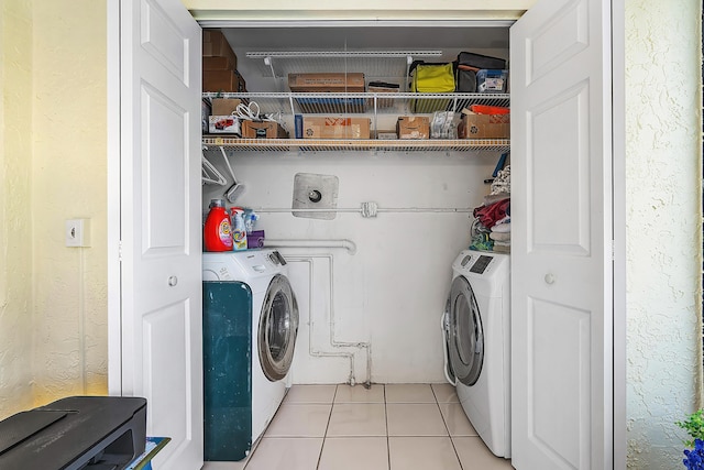 washroom featuring light tile patterned flooring and independent washer and dryer