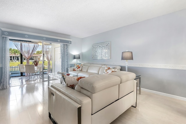 living room featuring a textured ceiling and light wood-type flooring