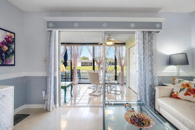 doorway to outside featuring ceiling fan and light hardwood / wood-style floors