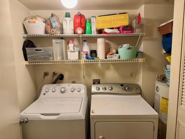 laundry area with electric water heater and washer and dryer