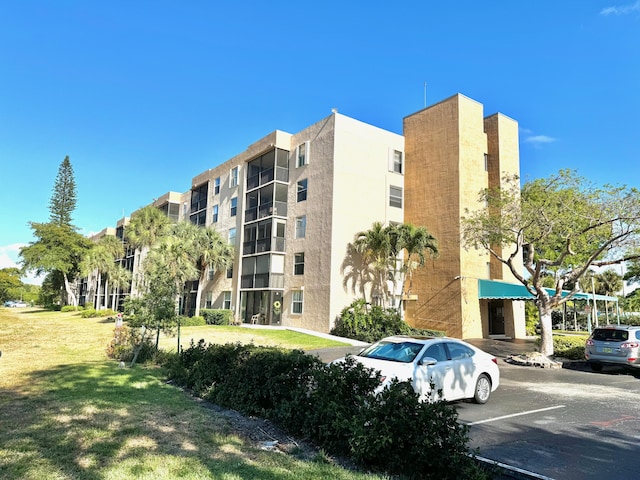 5280 NW 2nd Ave Unit 314, Boca Raton, FL 33487 - view of apartment building / complex featuring uncovered parking