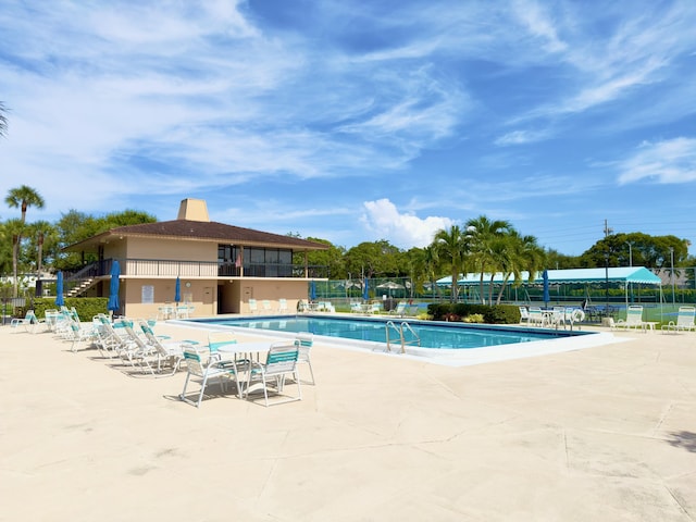 view of swimming pool featuring a patio area