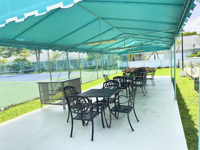5280 NW 2nd Ave Unit 314, Boca Raton, FL 33487 - view of patio featuring a tennis court and outdoor dining space