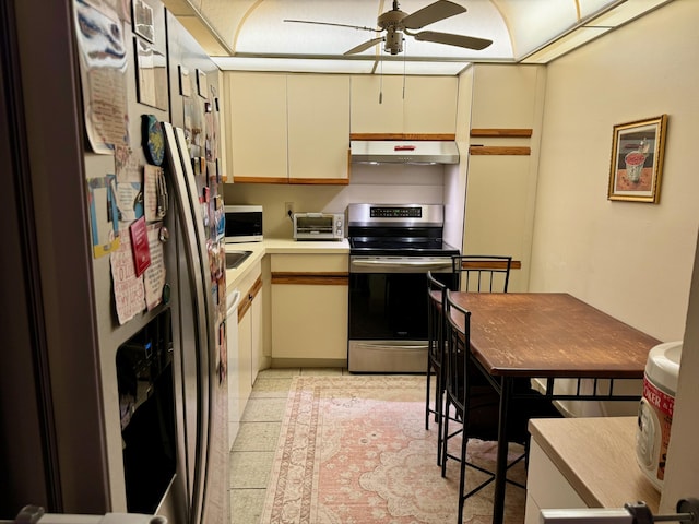 kitchen with ceiling fan, light tile patterned floors, stainless steel appliances, and cream cabinetry