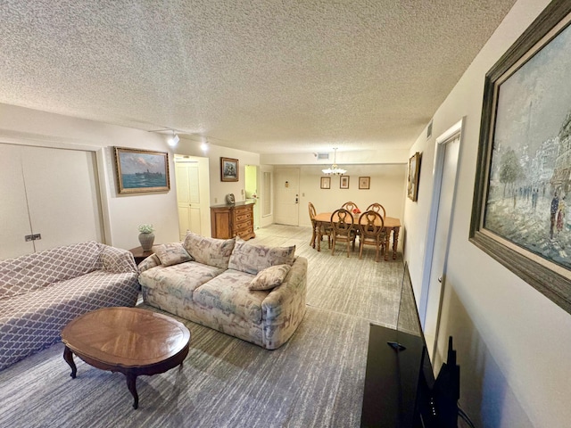 living room featuring light carpet and a textured ceiling