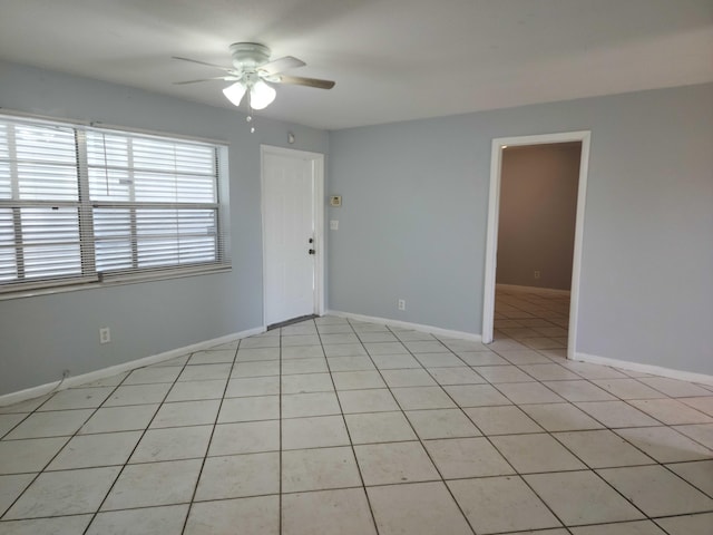 tiled empty room with ceiling fan