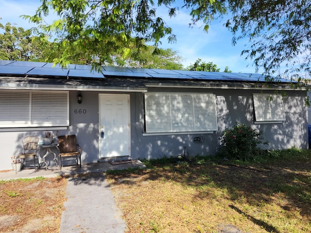 view of front facade featuring solar panels