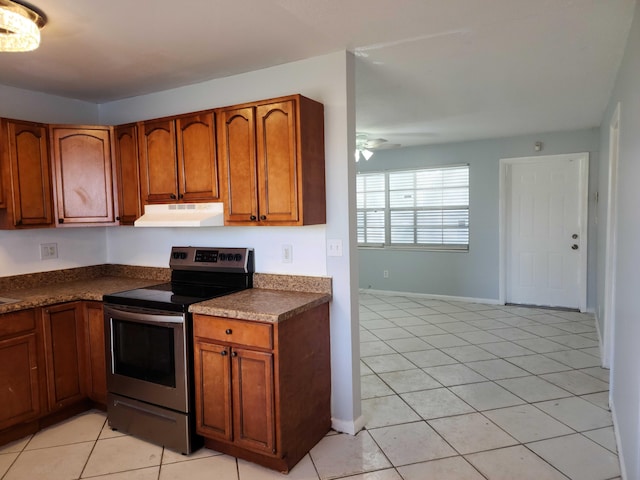 kitchen featuring light tile patterned flooring, ceiling fan, and stainless steel electric stove