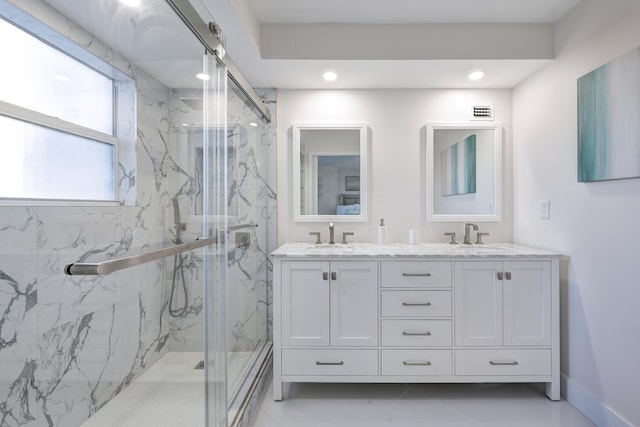 bathroom with vanity and a shower with shower door