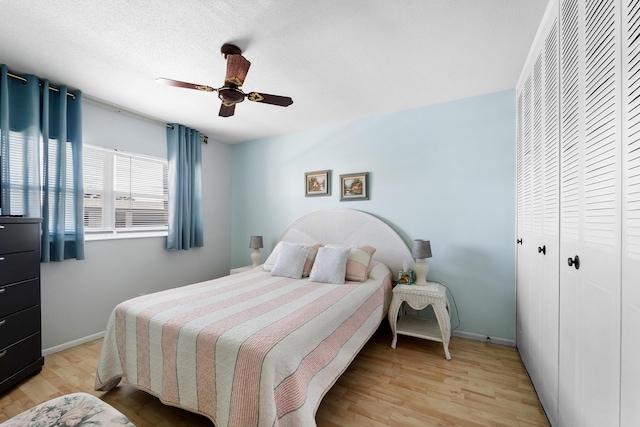 bedroom with ceiling fan and light hardwood / wood-style flooring