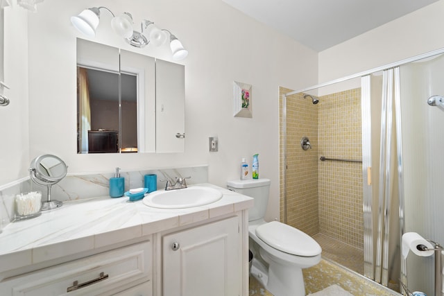 bathroom with vanity, an enclosed shower, and toilet