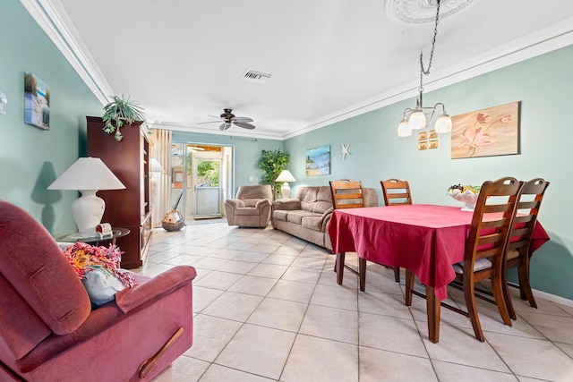 dining space with ceiling fan, ornamental molding, and light tile patterned flooring