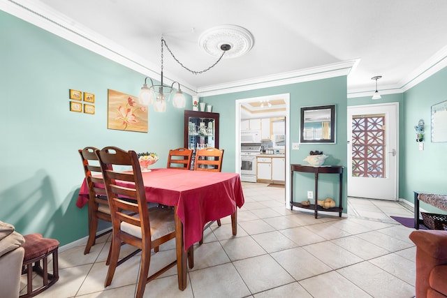 dining area with a notable chandelier, light tile patterned flooring, and ornamental molding