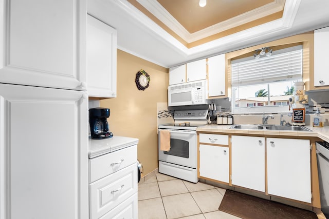 kitchen with sink, tasteful backsplash, crown molding, white appliances, and white cabinets