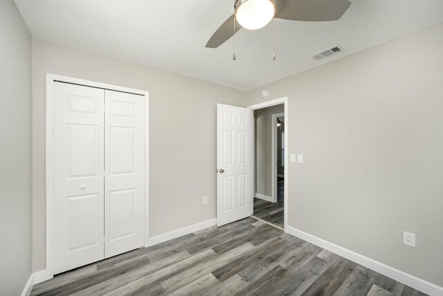 unfurnished bedroom with a closet, ceiling fan, and hardwood / wood-style flooring