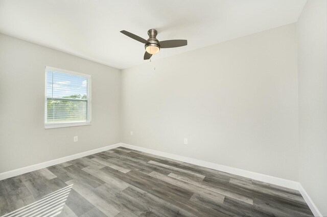 empty room with hardwood / wood-style floors and ceiling fan