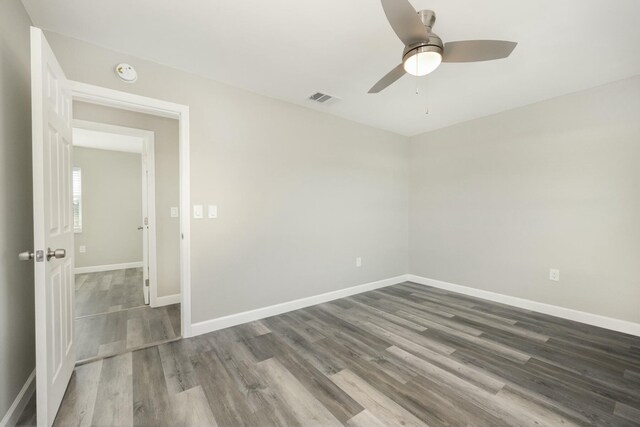 empty room featuring hardwood / wood-style flooring and ceiling fan