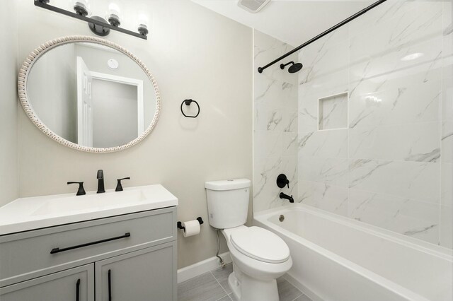 full bathroom with tile patterned floors, toilet, vanity, and tiled shower / bath