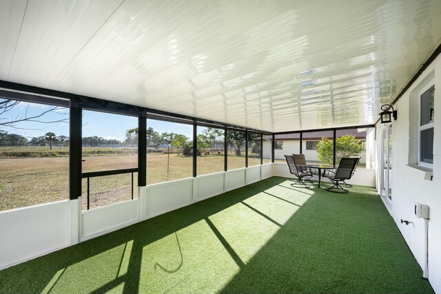 unfurnished sunroom with a rural view