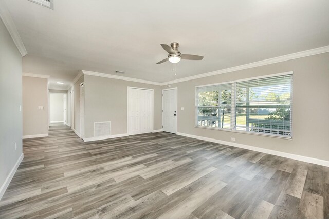 spare room featuring ceiling fan, wood-type flooring, and ornamental molding