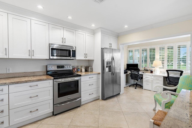 kitchen with light stone countertops, light tile patterned floors, crown molding, white cabinets, and appliances with stainless steel finishes