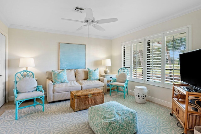 living room with ceiling fan and ornamental molding