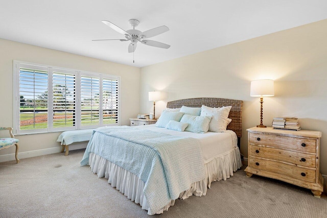 bedroom featuring light carpet and ceiling fan