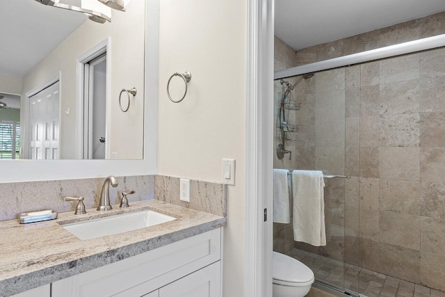 bathroom with vanity, toilet, and walk in shower