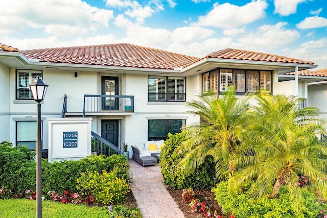 mediterranean / spanish-style home with a balcony