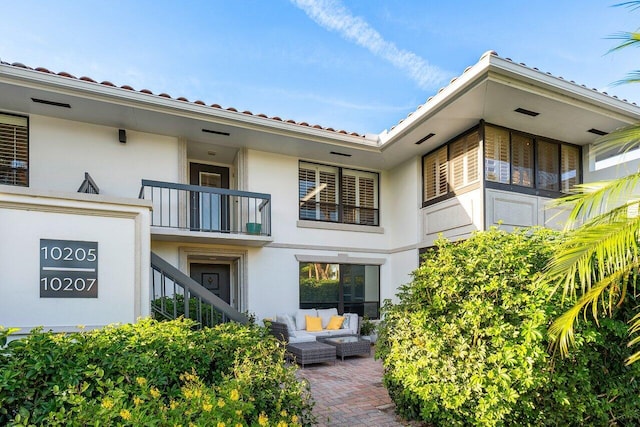 rear view of house featuring outdoor lounge area and a patio area