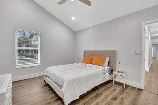 bedroom with ceiling fan, high vaulted ceiling, and wood-type flooring