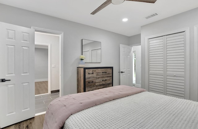 bedroom with ceiling fan, dark hardwood / wood-style flooring, and a closet