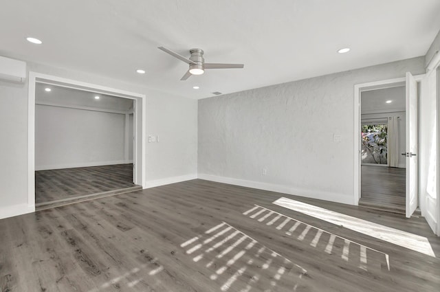 unfurnished bedroom featuring ceiling fan, dark hardwood / wood-style flooring, a closet, and an AC wall unit