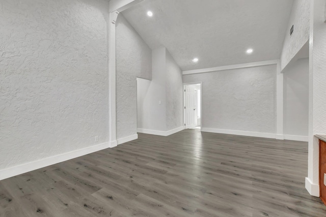 unfurnished living room with dark hardwood / wood-style flooring and a towering ceiling