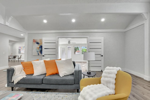 living room with vaulted ceiling and light hardwood / wood-style flooring