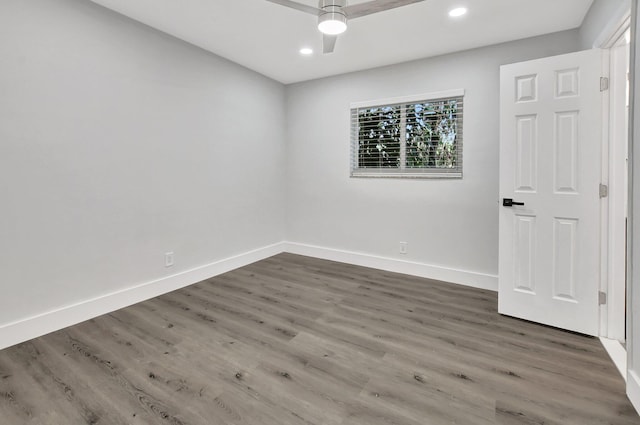 unfurnished room featuring ceiling fan and dark hardwood / wood-style floors