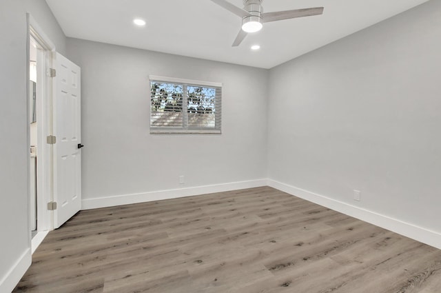 empty room with ceiling fan and hardwood / wood-style floors