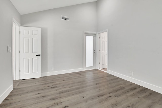 empty room with hardwood / wood-style flooring