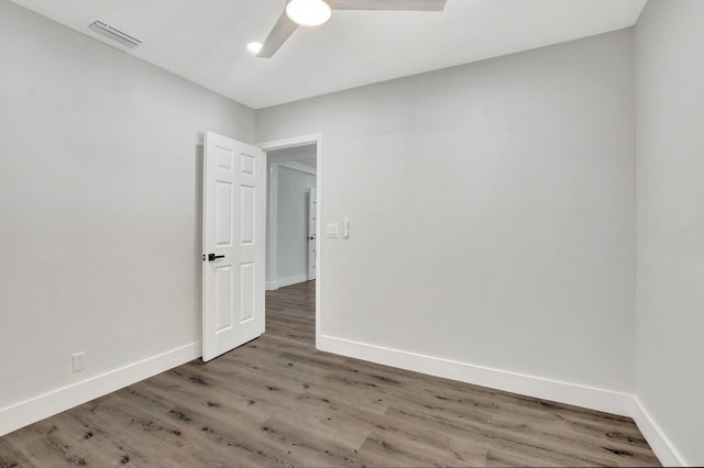 empty room with hardwood / wood-style flooring and ceiling fan