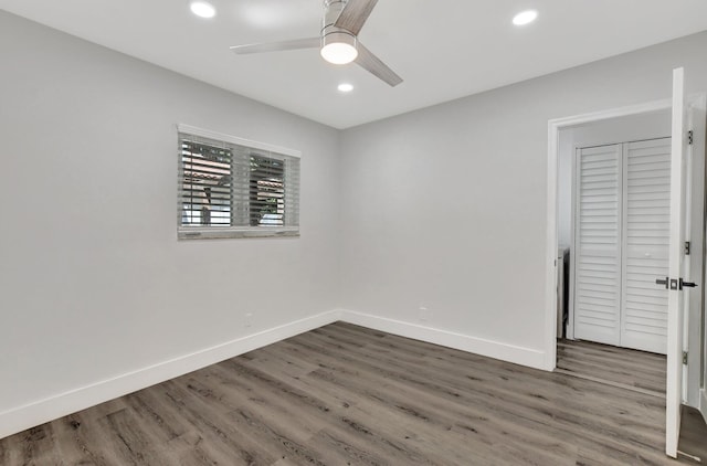 unfurnished bedroom featuring a ceiling fan, baseboards, dark wood-type flooring, and recessed lighting