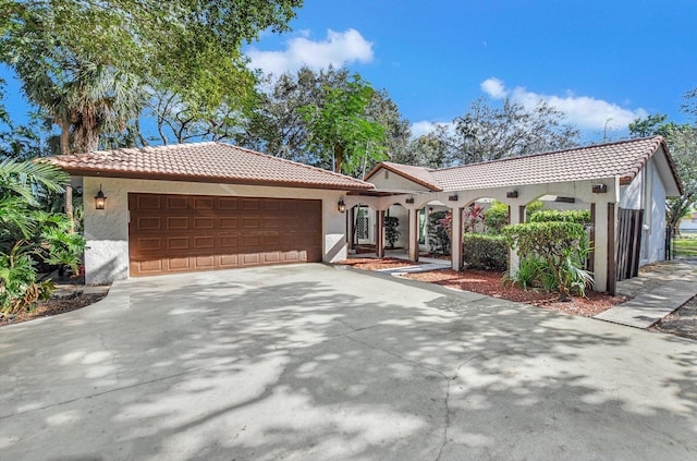 mediterranean / spanish-style house with a garage