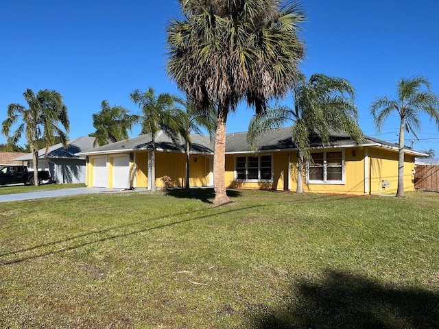 single story home with a garage and a front lawn