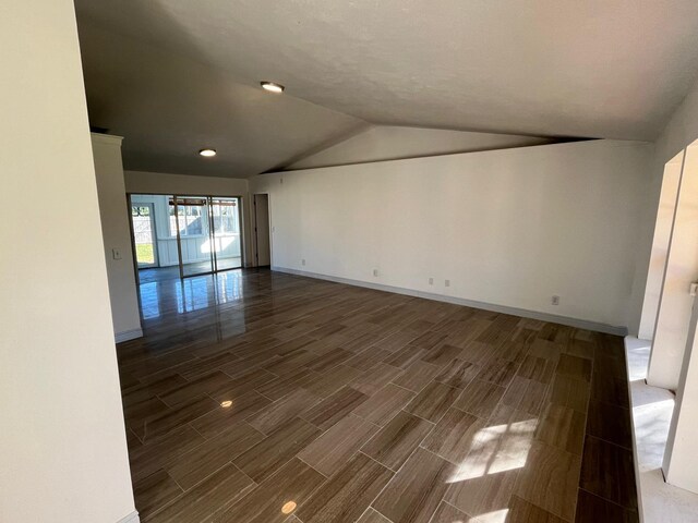 unfurnished room featuring vaulted ceiling