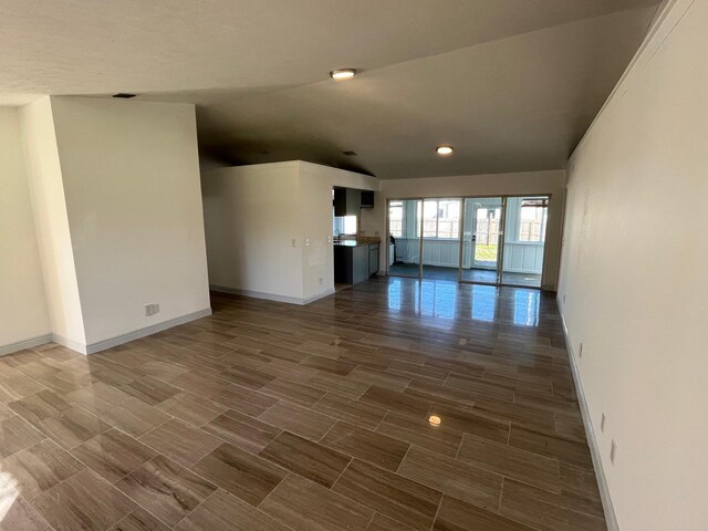 unfurnished living room with lofted ceiling