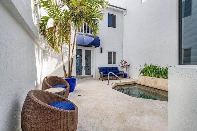 view of swimming pool with outdoor lounge area, french doors, and a patio