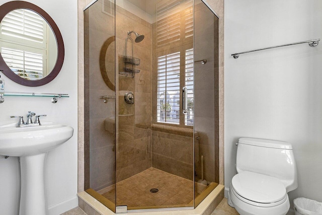 bathroom with toilet and a shower with shower door