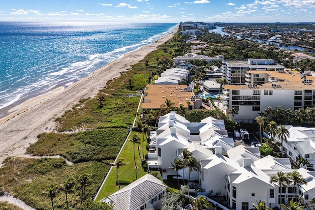 drone / aerial view featuring a water view and a beach view